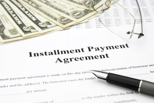 installment payment agreement document with glasses and filler